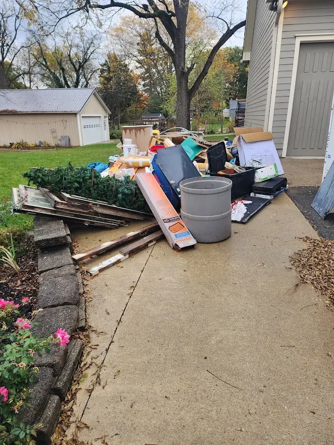 Dumpster being loaded with debris for Roofing Dumpster Rental in Glenwood